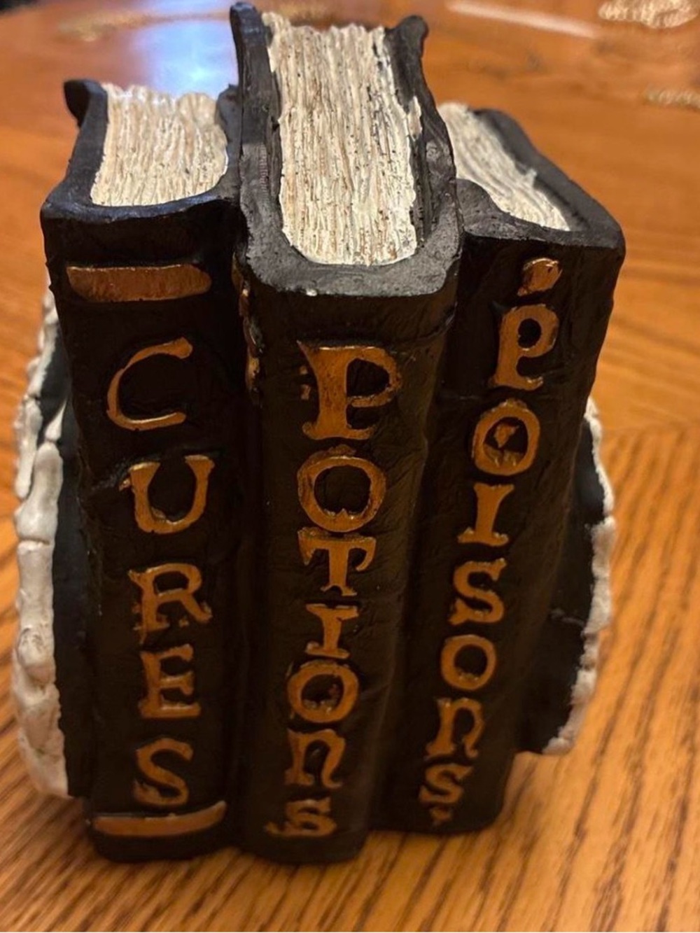 Halloween decor book stack cures potions and poisons